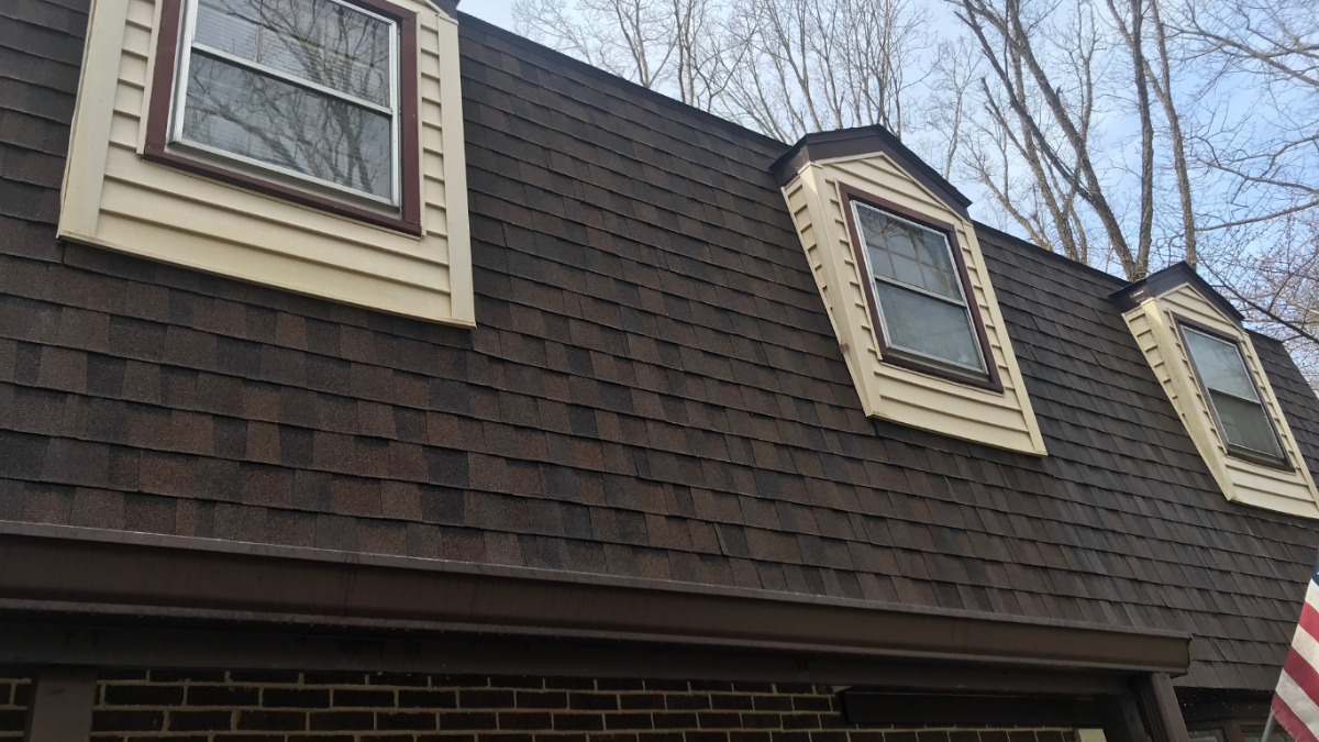 Newington CT home with roof ice dams and icicles showing winter roof damage, gutter cleaning, attic insulation, and ice dam prevention tips.