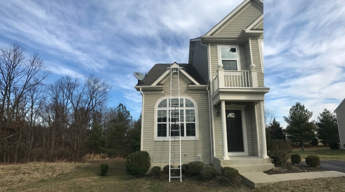 Traditional Cape Cod home in Newington with steep roof, two dormers and aluminum siding.