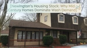 Newington housing stock featuring a mid-century cape-style home with aluminum siding, dormer windows and an asphalt shingle roof.